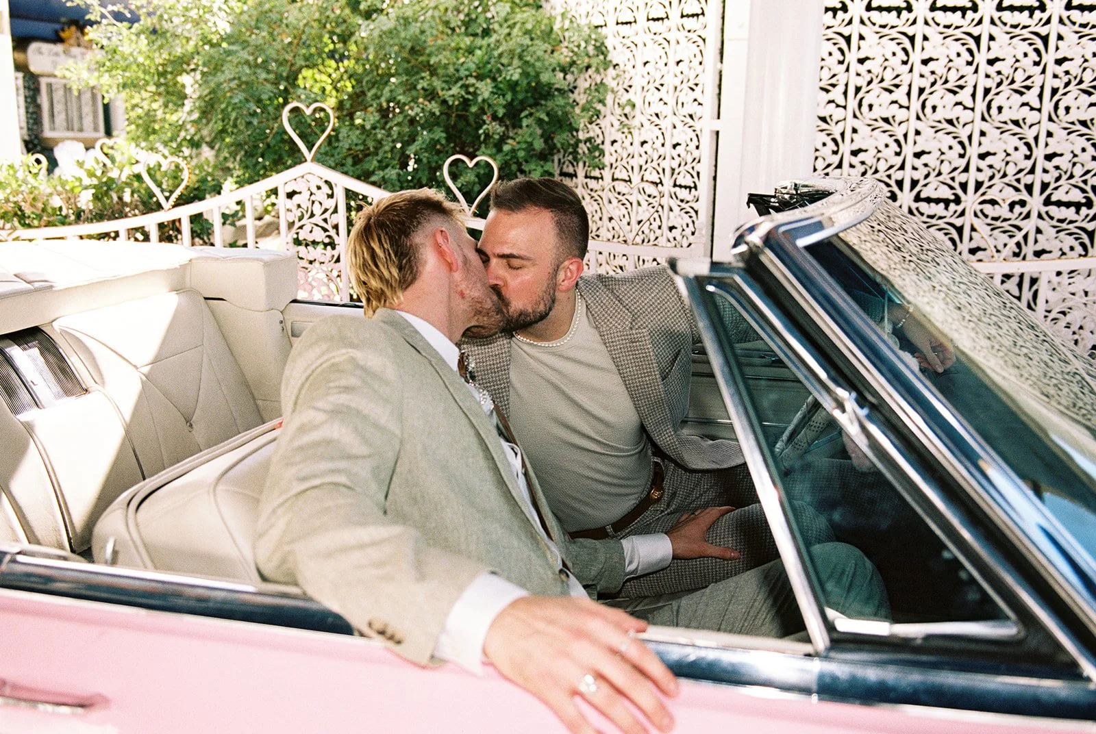 Couple kissing inside the Pink Cadillac at a Little White Wedding Chapel in Las Vegas on 35mm film.