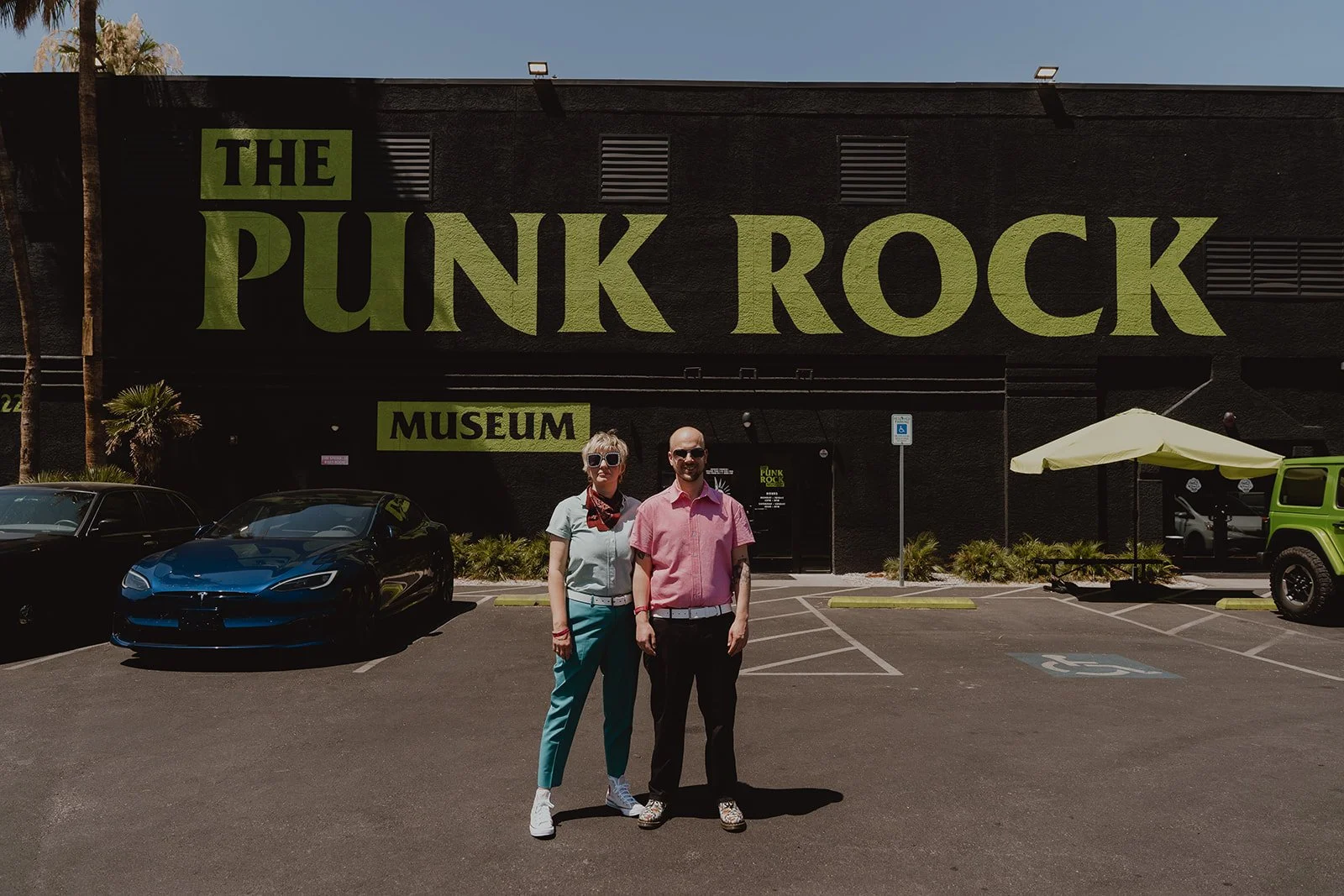 Couple posing in front of The Punk Rock Museum - a unique Las Vegas wedding venue.
