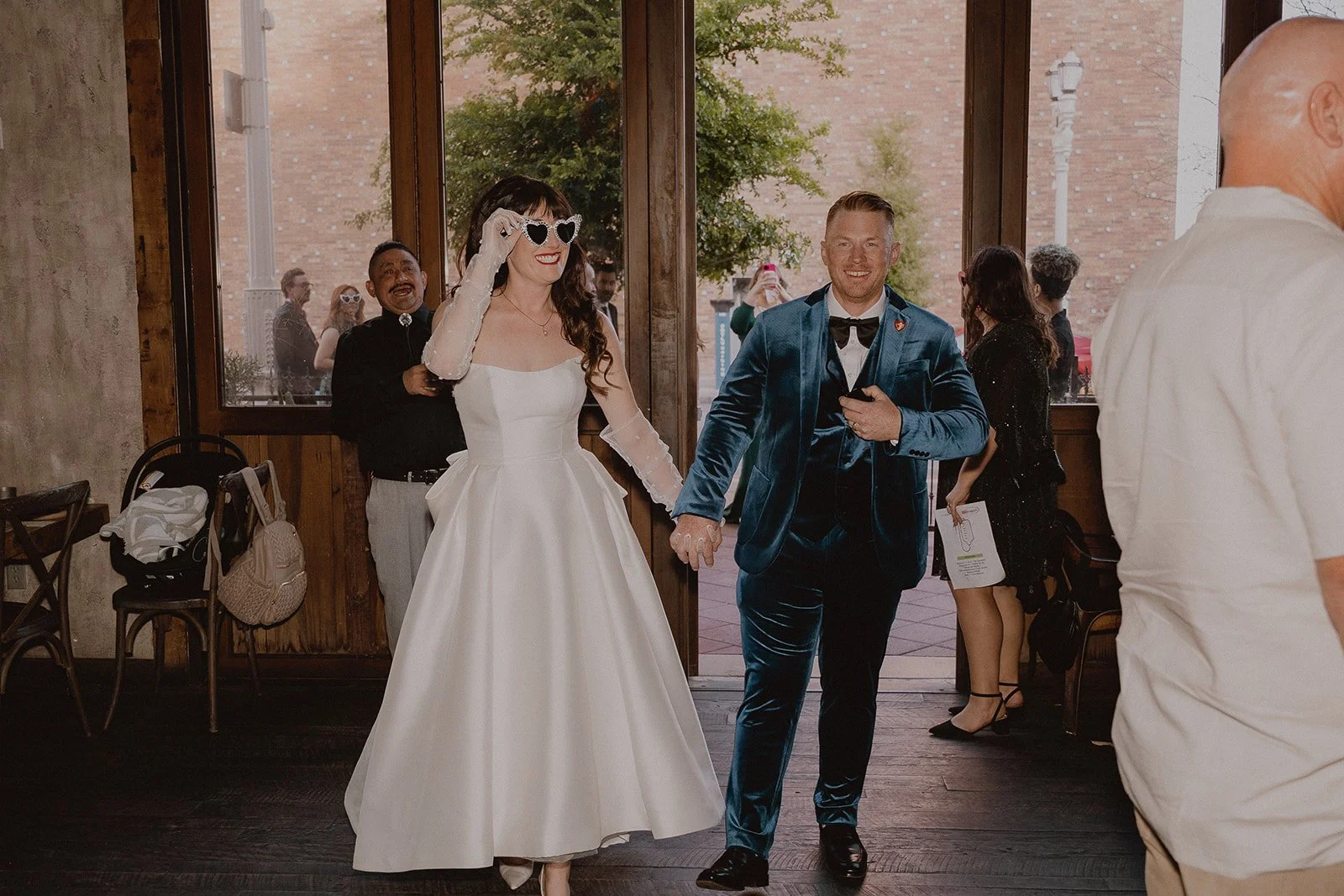 Bride and groom entering La Mona Rosa wedding reception in Las Vegas.