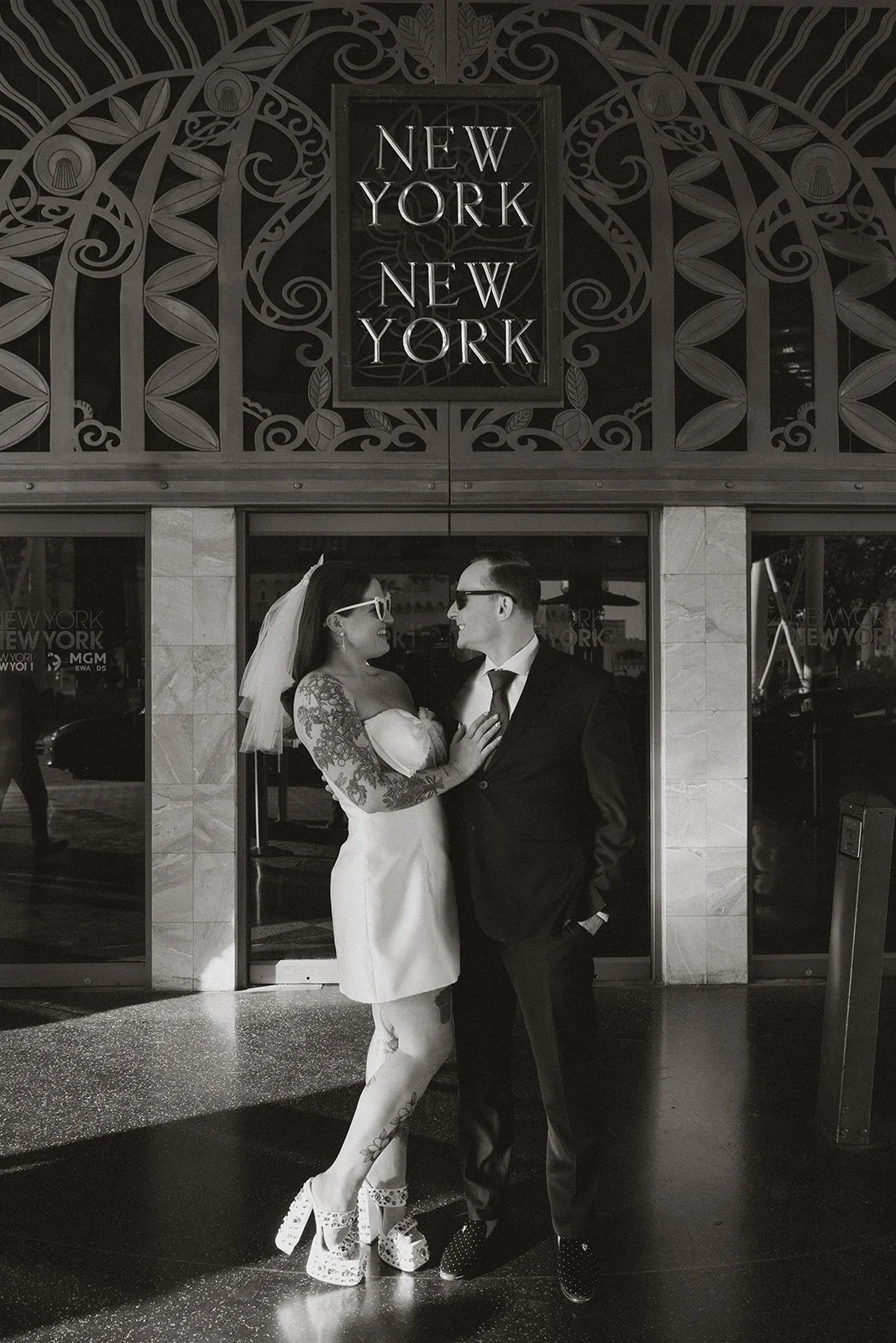 Couple standing together after their first look inside New York-New York Hotel & Casino in Las Vegas.