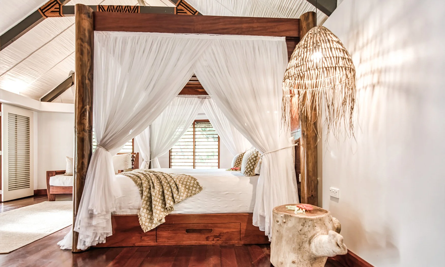 luxury-matangi-island-accommodation-ocean-view-bure-canopy-bed.jpg