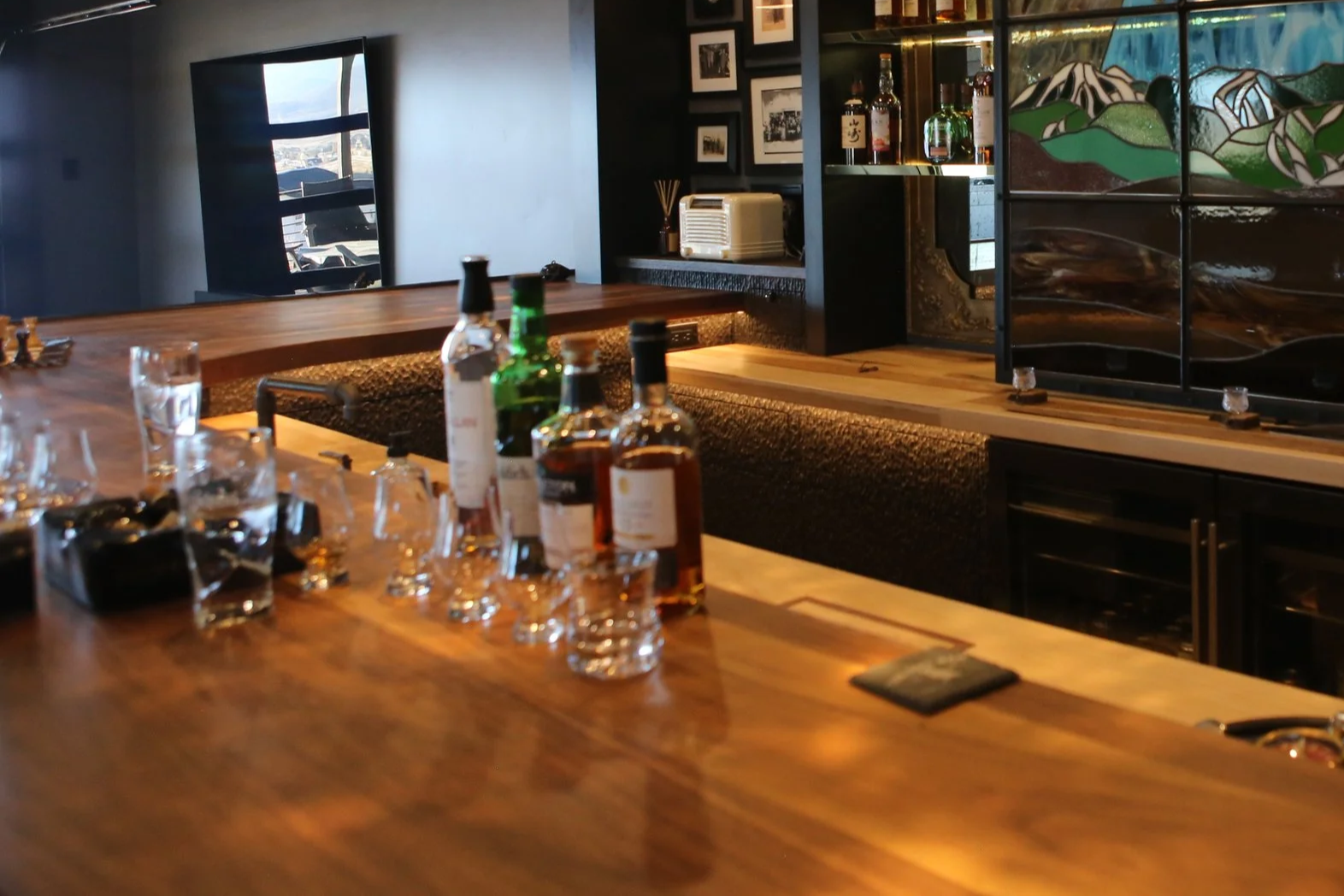 Textured white oak cabinets with a dark stain give the gritty look of a bar with character. 