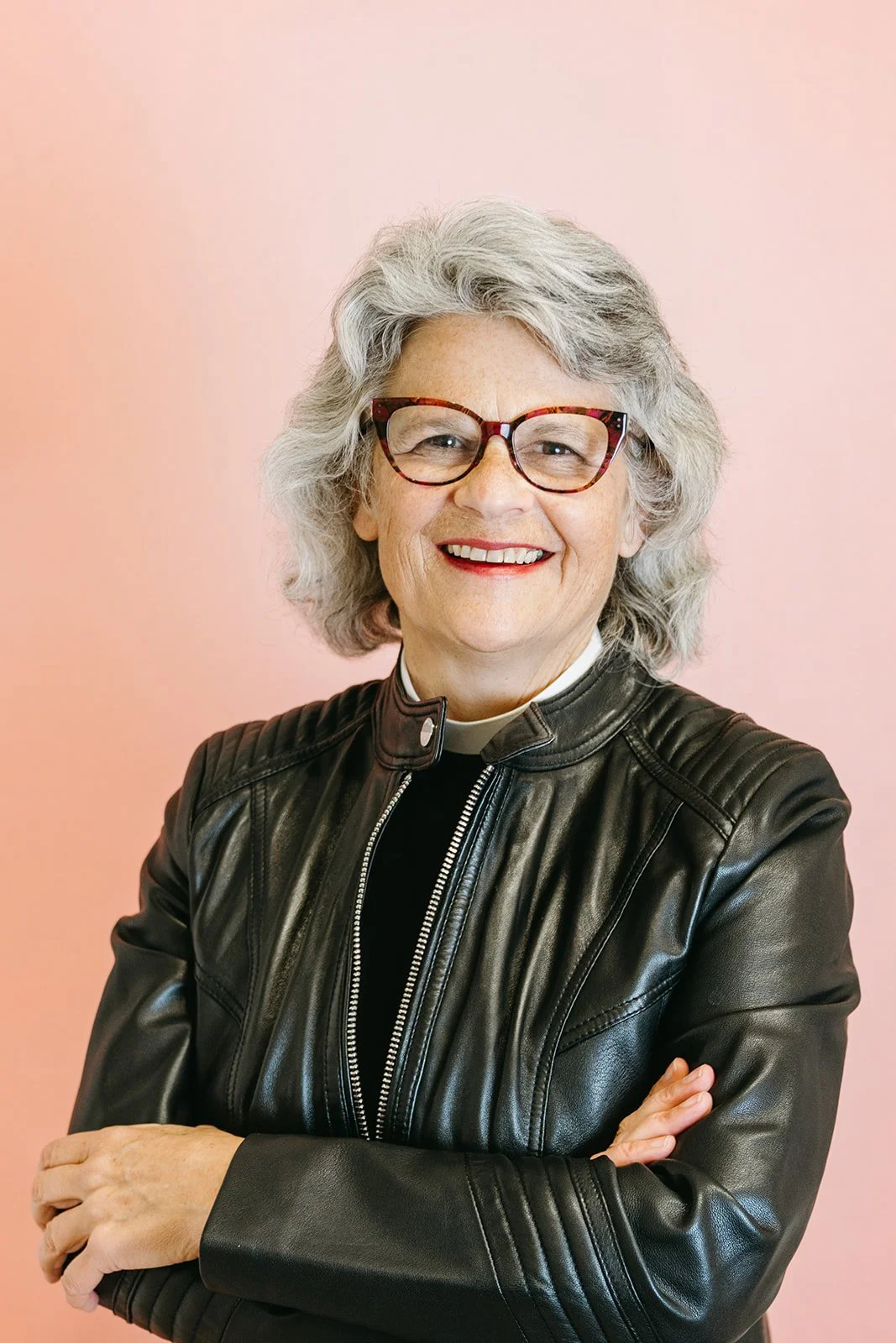 strong-female-pastor-headshot-pink-backdrop-portland-oregon.jpg