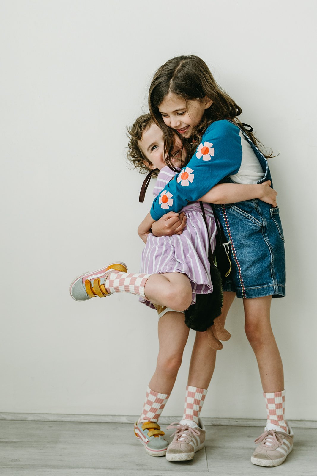sisters-hugging-fun-studio-portrait-portland-oregon.jpg