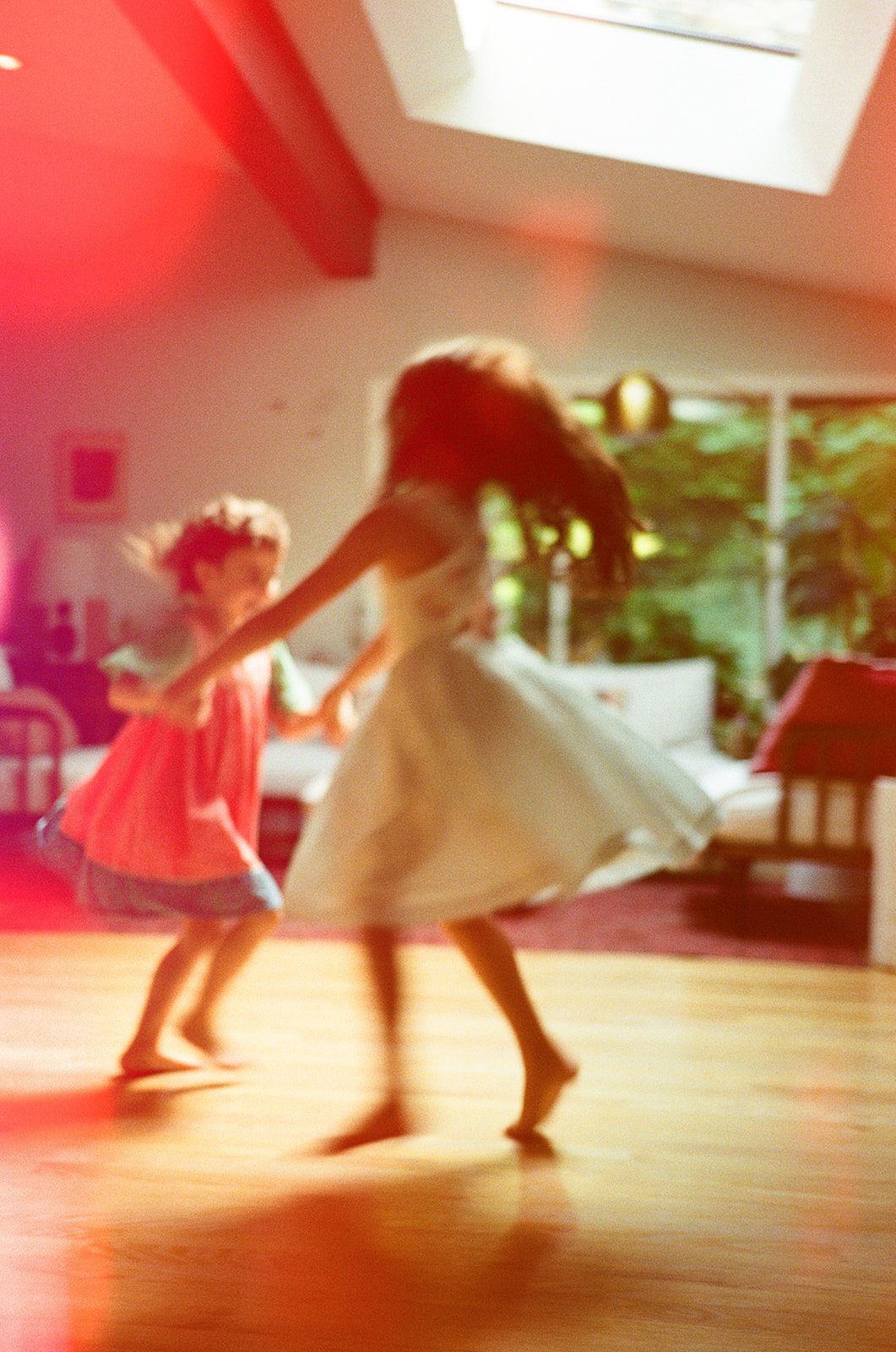 sisters-dancing-home-colorful-playful-light-leak-film-photo-portland-oregon.jpg