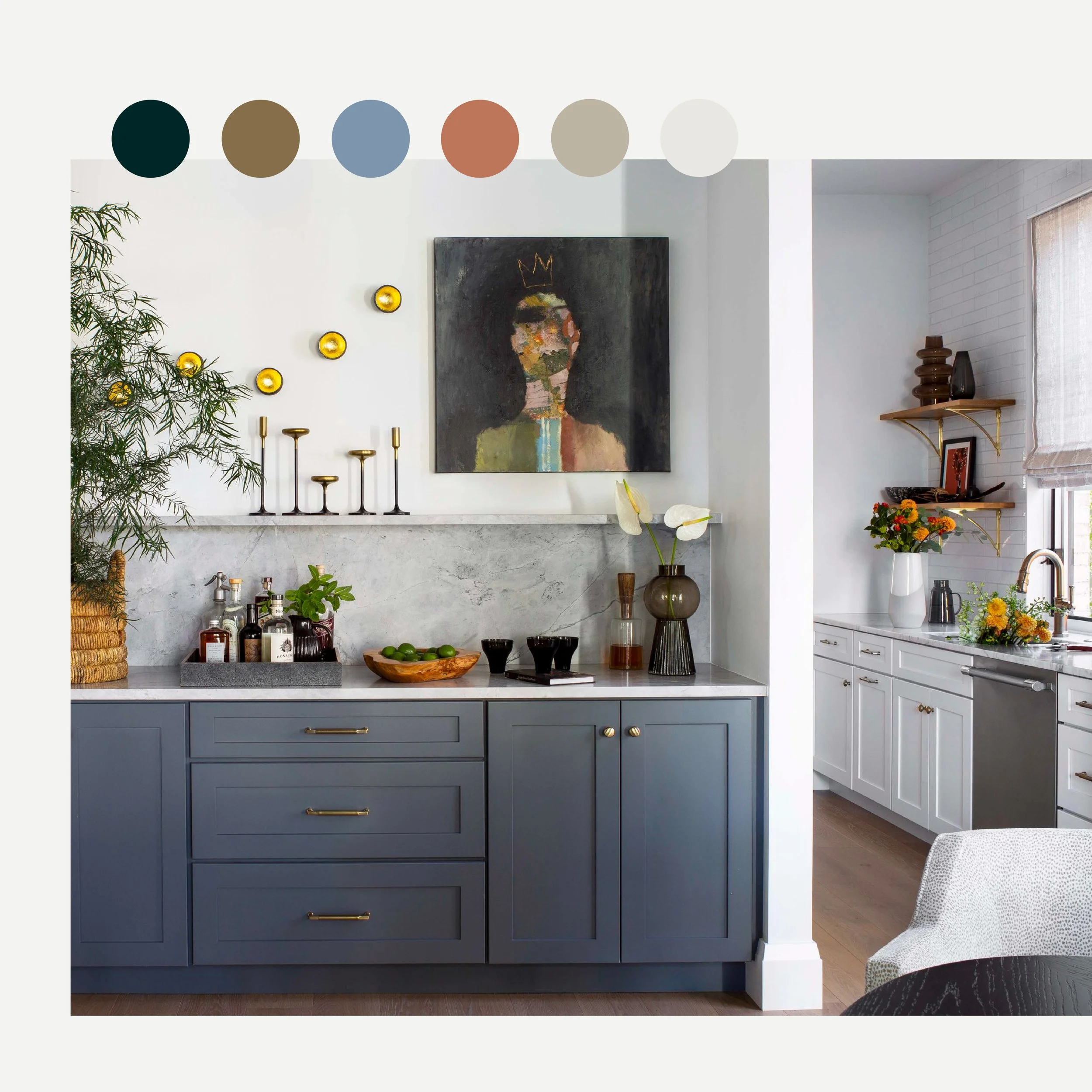 Modern kitchen with blue and white cabinets, a marble backsplash, decorative candles, vases with flowers, and abstract artwork with a crown on a figure's head.