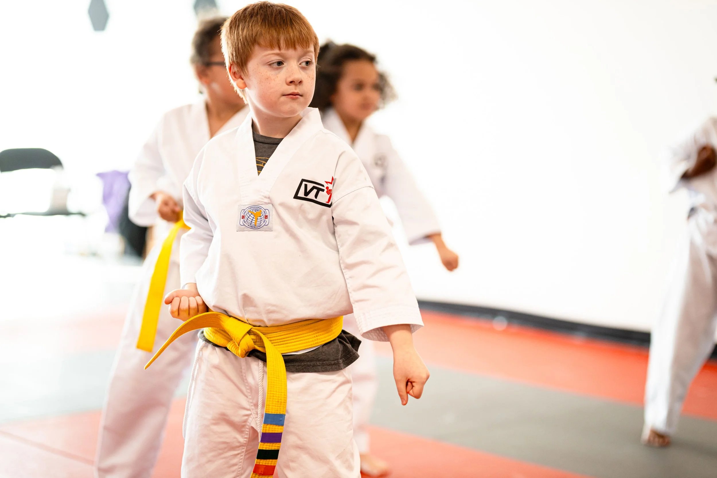 Vertical Taekwondo Lees Summit Student does a Karate/Taekwondo block with focus
