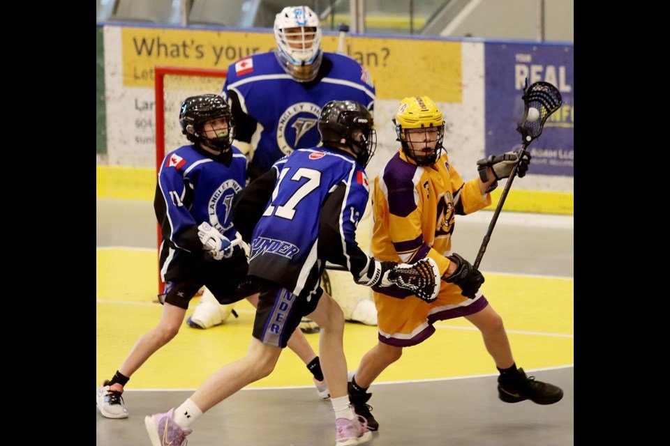  Coquitlam Adanacs forward Malcolm Richardson tries to get around a pair of Langley defenders in their Bantam game at the Trevor Wingrove Memorial lacrosse tournament, Friday at the Poirier Sport and Leisure Complex.  MARIO BARTEL/THE TRI-CITY NEWS 