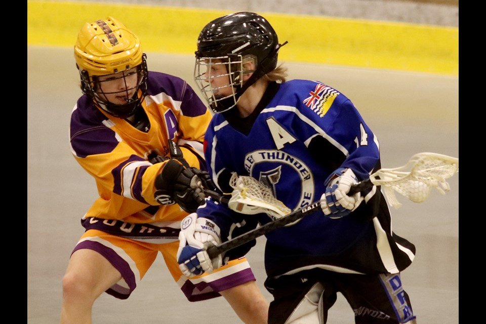  MARIO BARTEL/THE TRI-CITY Coquitlam Adanacs defender Matty Dane checks Langley Thunder forward Matthew Claxton in the first period of their Bantam game at the Trevor Wingrove Memorial lacrosse tournament, Friday at the Poirier Sport and Leisure Comp