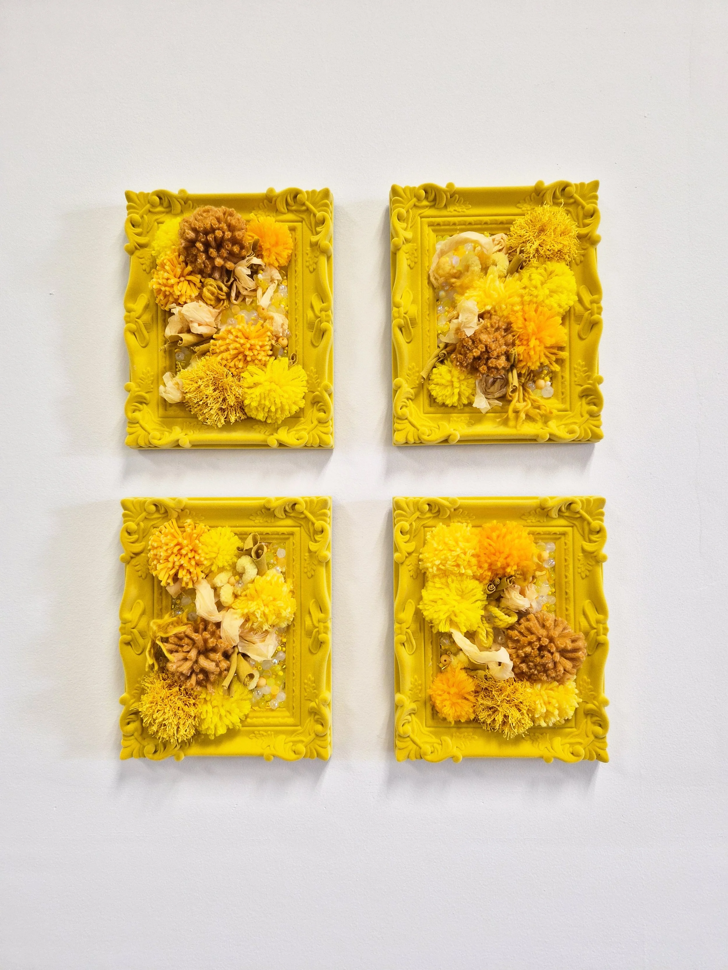 A composition of interwoven fibers, beads, and paper mounted in velvet frames