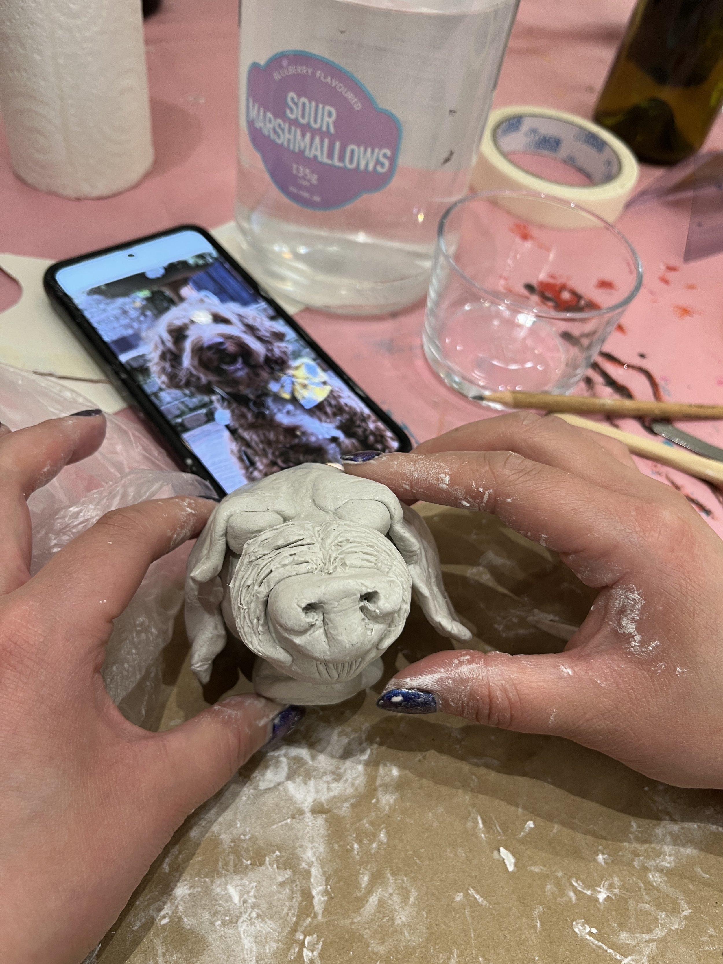 Make Art - Eat Cake participant sculpting their dog.JPG