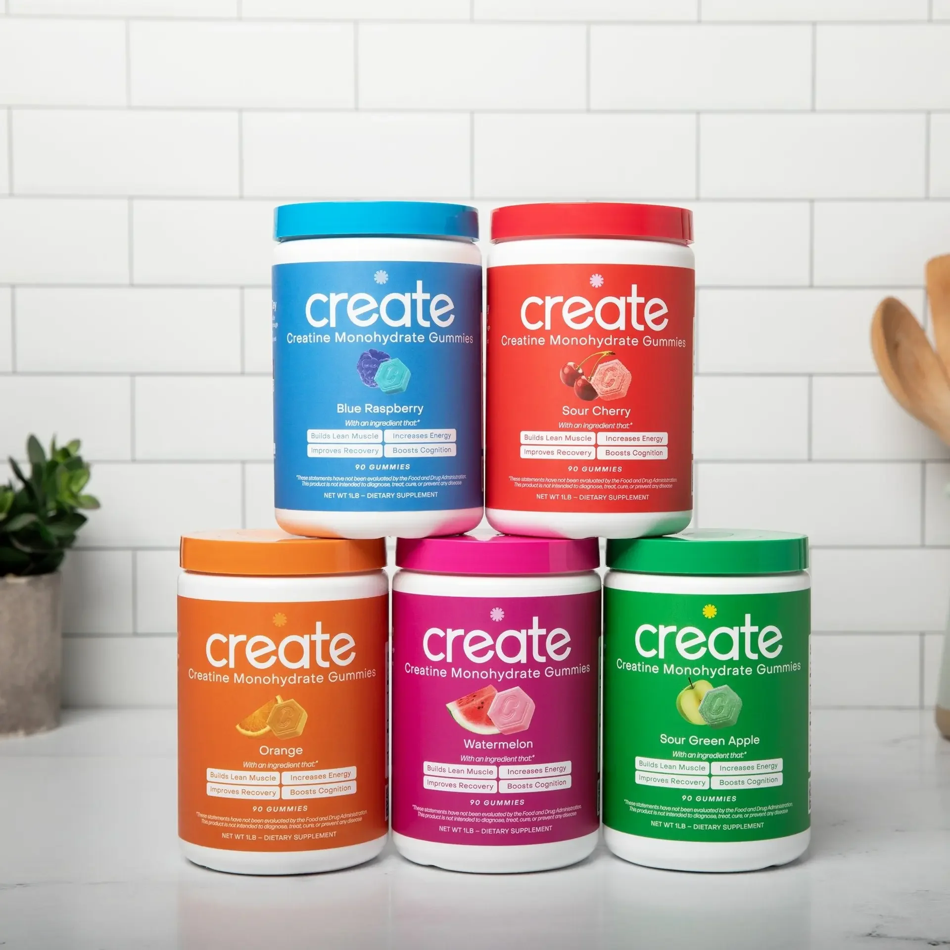 Photo is of 5 create creatine containers on a kitchen counter