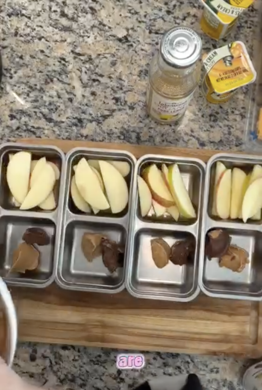 Photo is of apples getting prepped in snack containers for kids snack boxes and meal prep