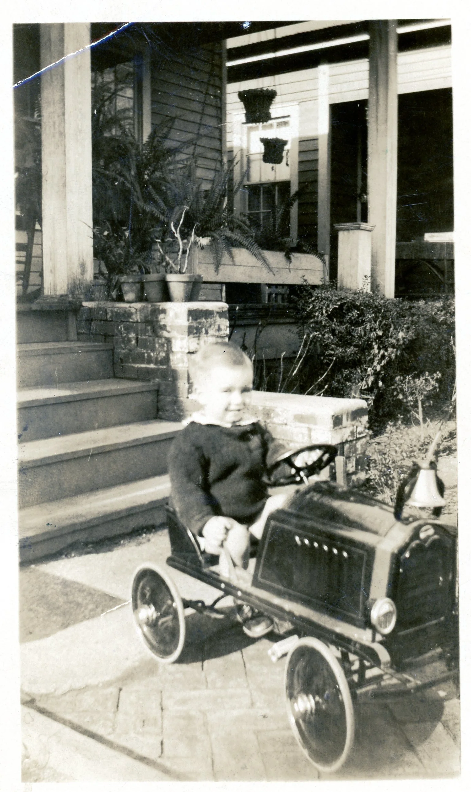 Toddler Tom in his fire engine truck, 1929