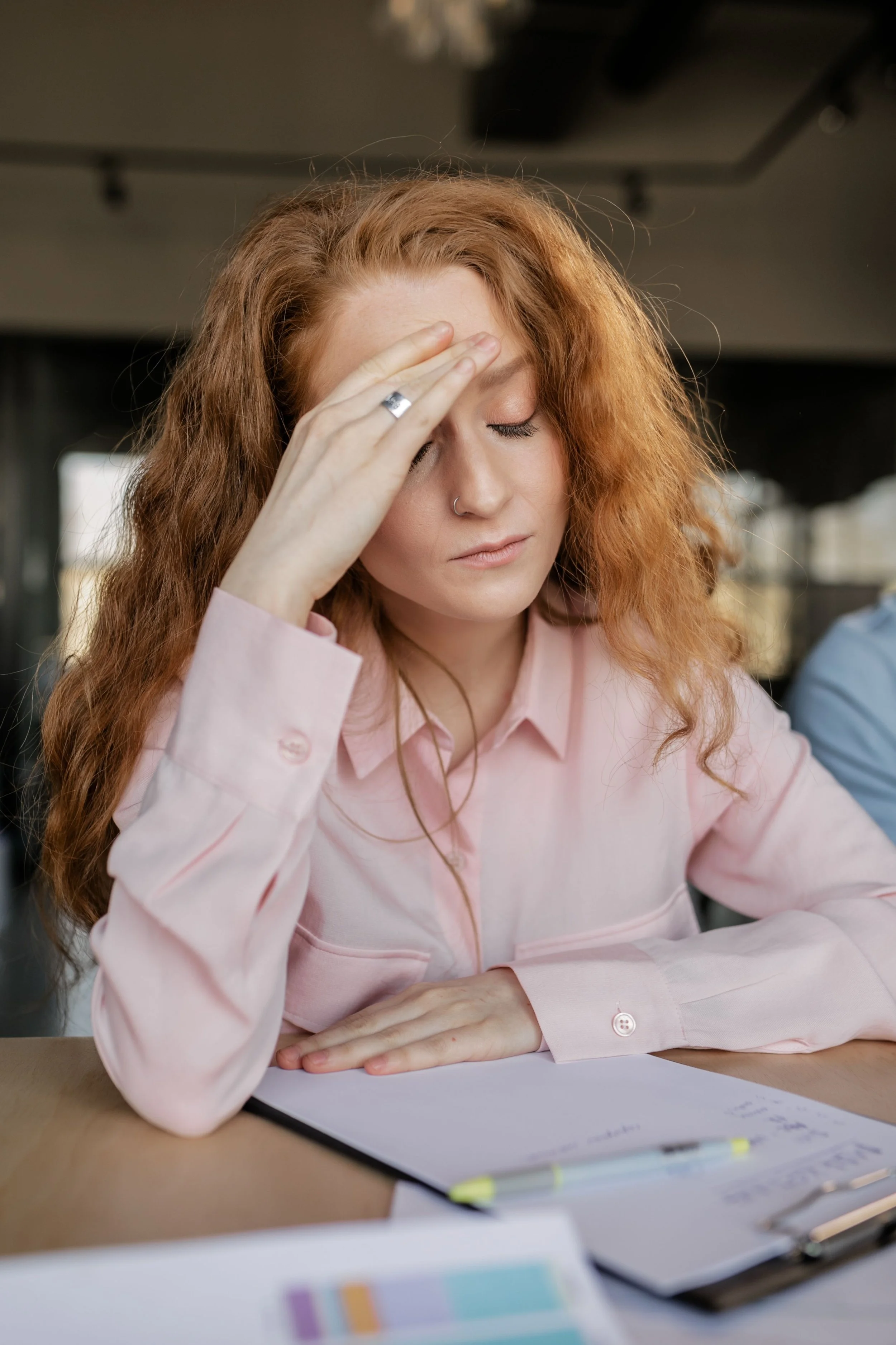 Person experiencing mental fatigue while working at a desk
