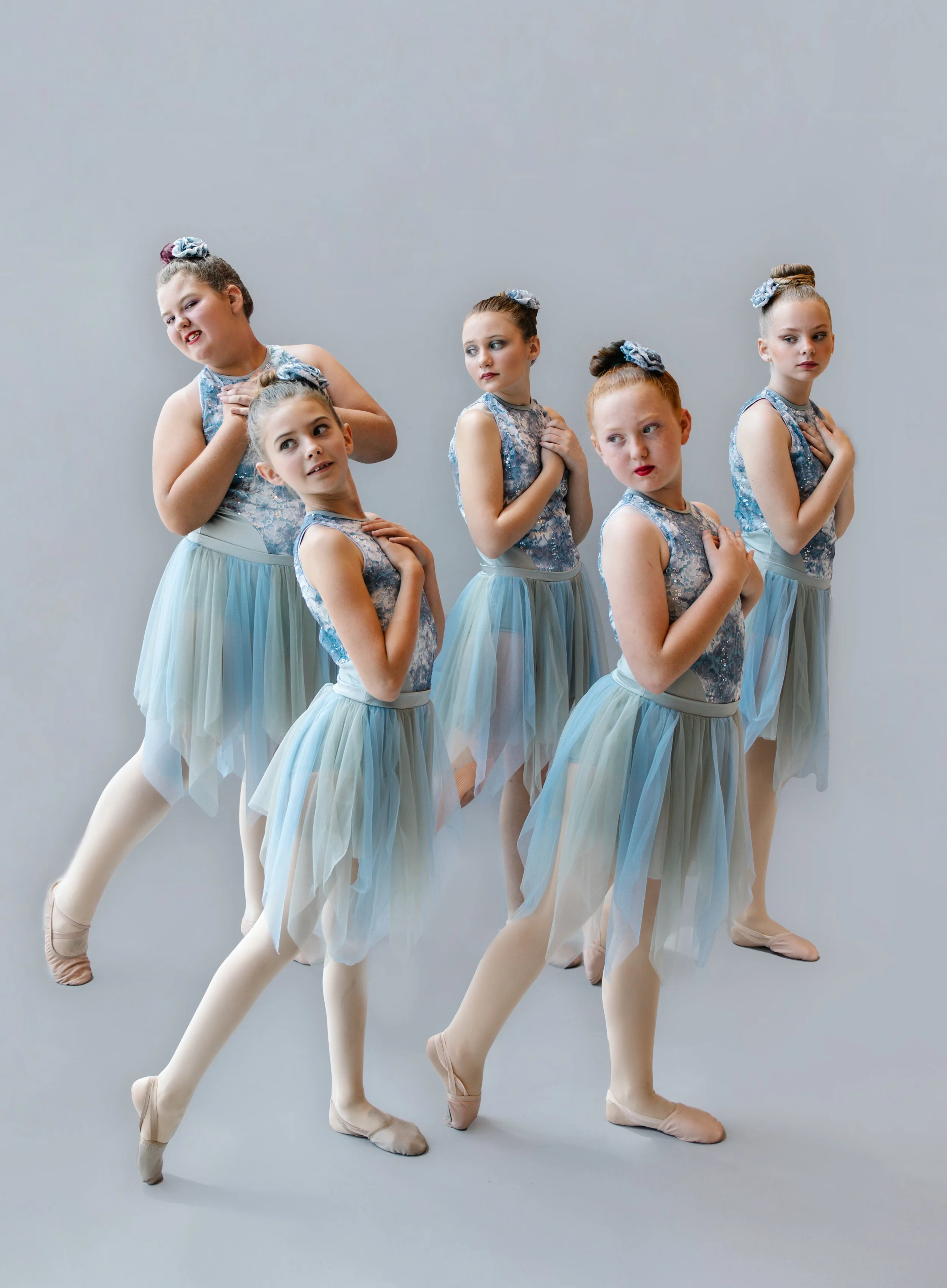 Five young dancers in matching blue floral leotards and flowing skirts posing gracefully in a studio for Crazy Moves Dance’s “Falling Like Stars” performance..jpg