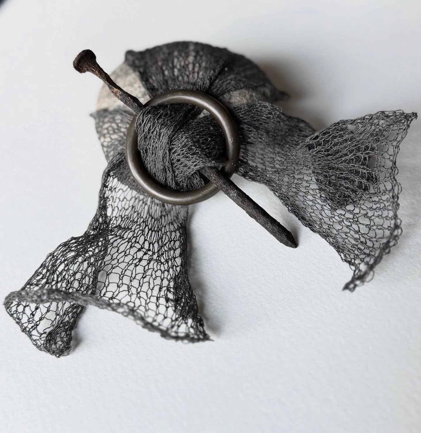 I&rsquo;ve been thinking about ways we enclose or contain ourselves. Wrapped up in a shawl, one is comforted, held. Piercing this softness is what holds it in place.

&lsquo;SHAWL PIN&rsquo;

(Stone, silk/stainless steel thread, rusted nail, vintage 