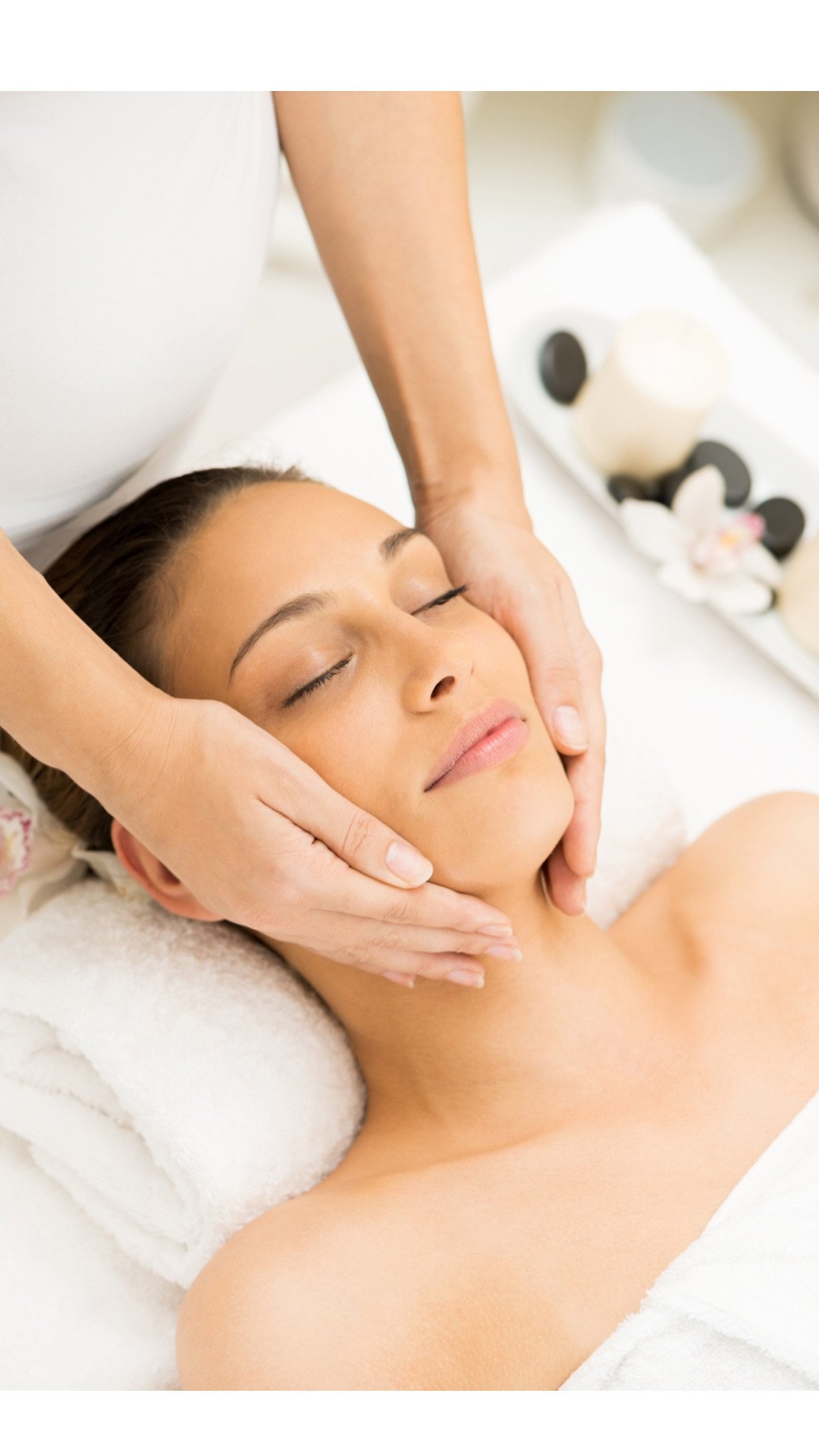 A woman receiving a facial massage at a spa
