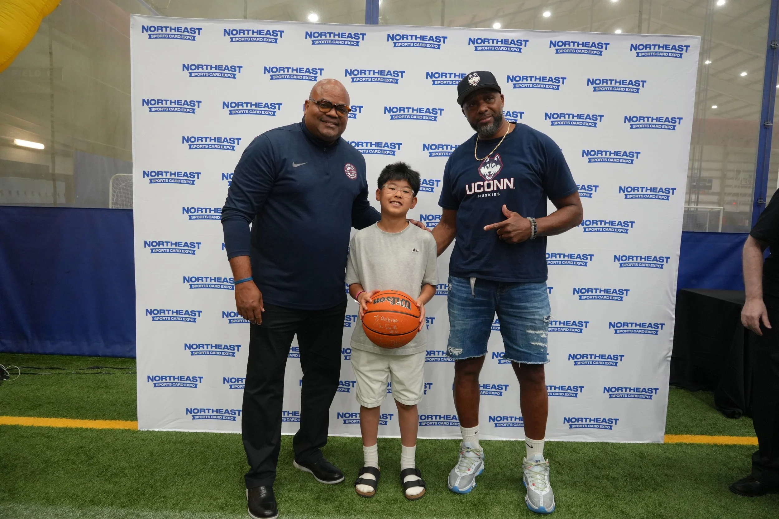 Uconn legends Chris Smith and Lymon Depriest with a raffle prize winner