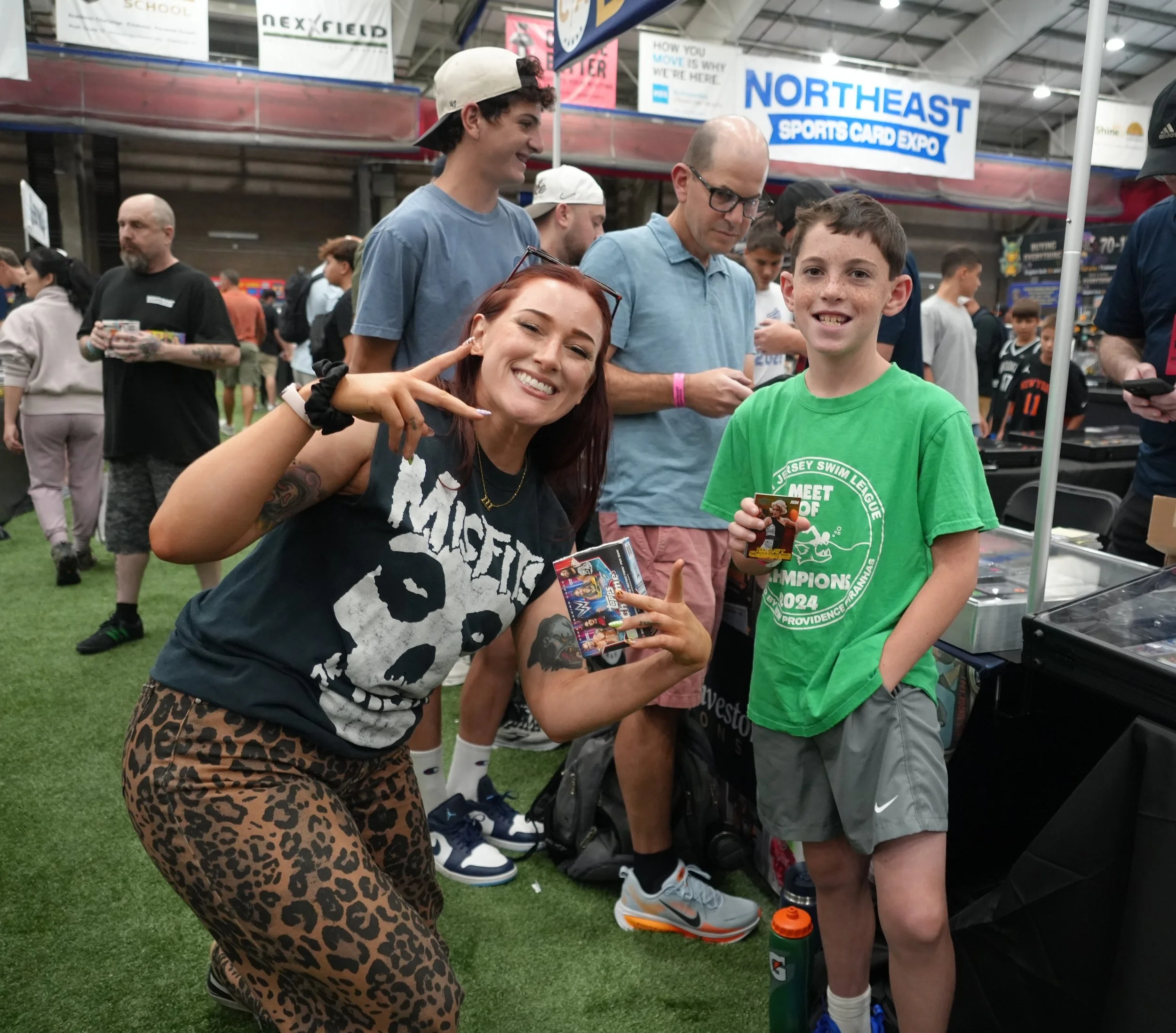 Wrestler Allie Katch hands out free packs of cards to kids at the show
