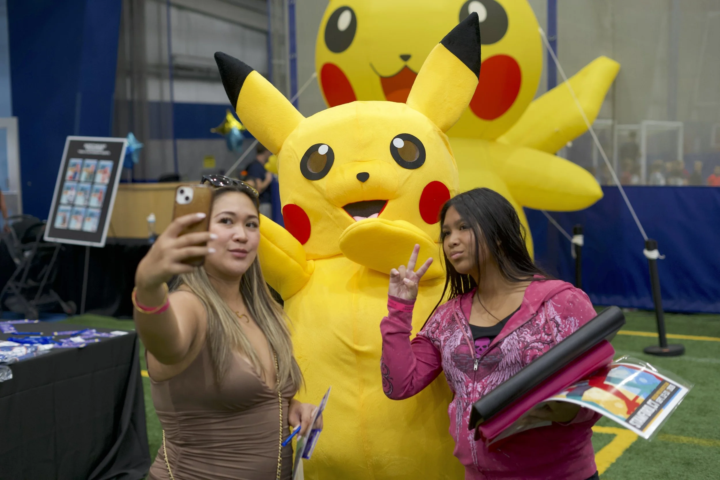 Attendees at the Northeast Sports Card Expo in Stamford, Connecticut taking a selfie with Pikachu