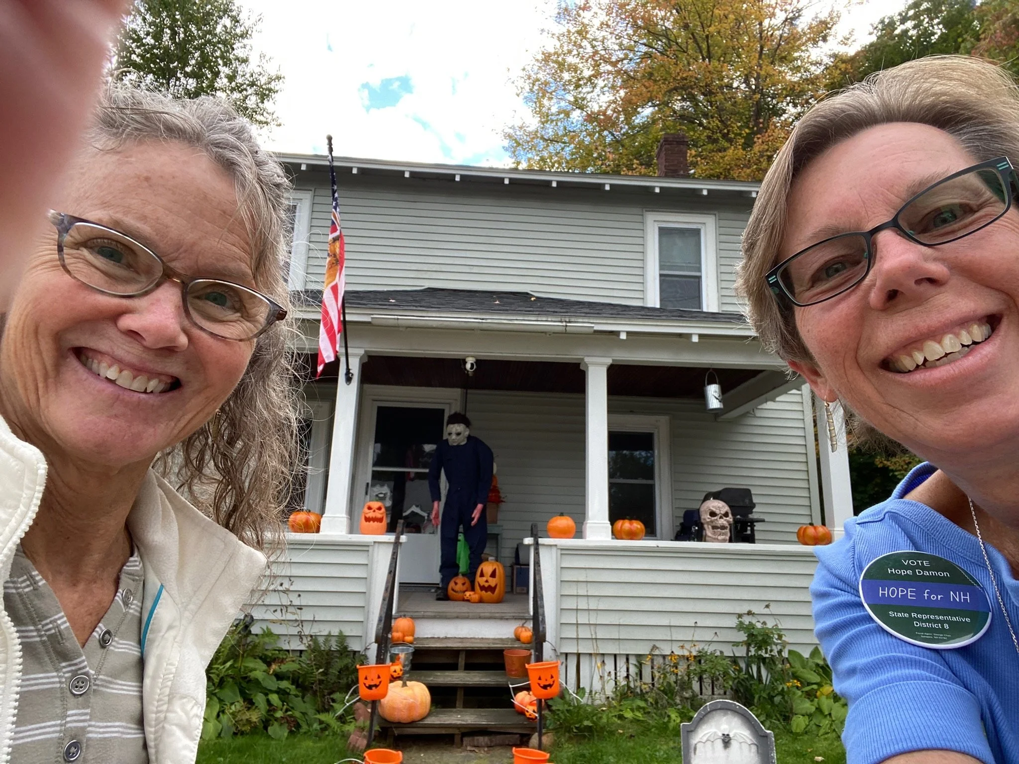 Hope and a volunteer admire Halloween decorations while door knocking