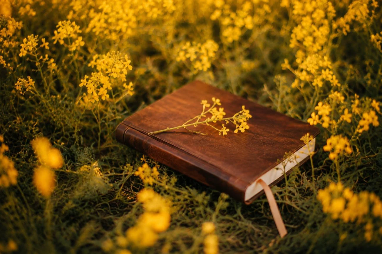 a closed journal in a flower field