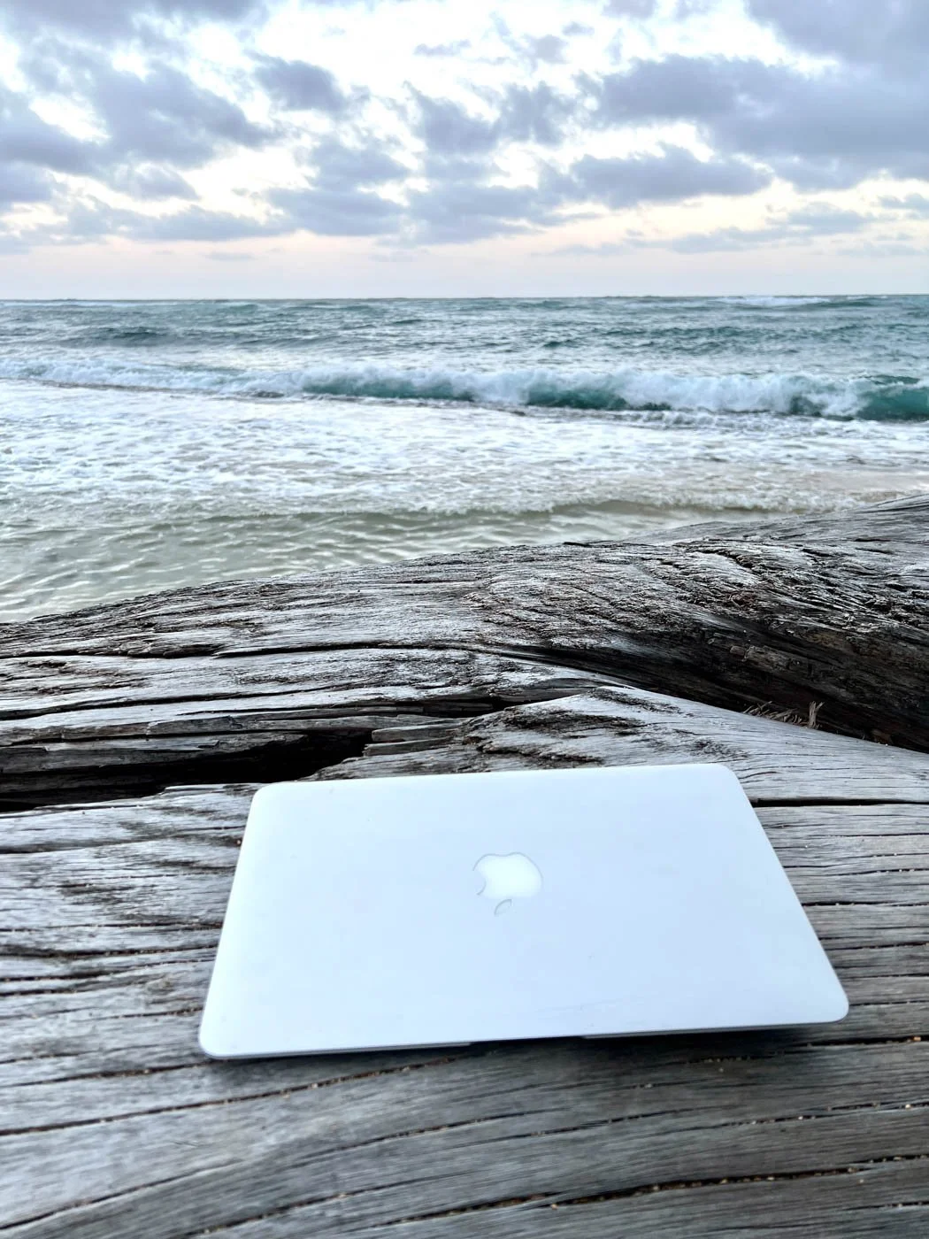 a closed laptop on the beach