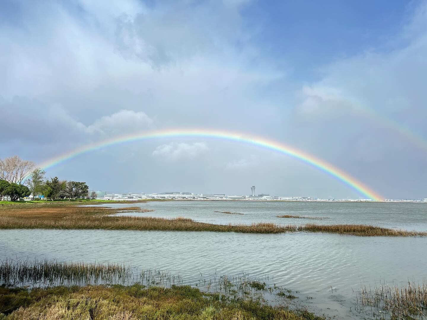 Rainbow over airport&hellip; from a recent walk on the SF bay trail, this photo has so many of the elements of landscape that are interesting to me: the intersection of nature and urban infrastructure, captured during an atmospheric river storm&helli