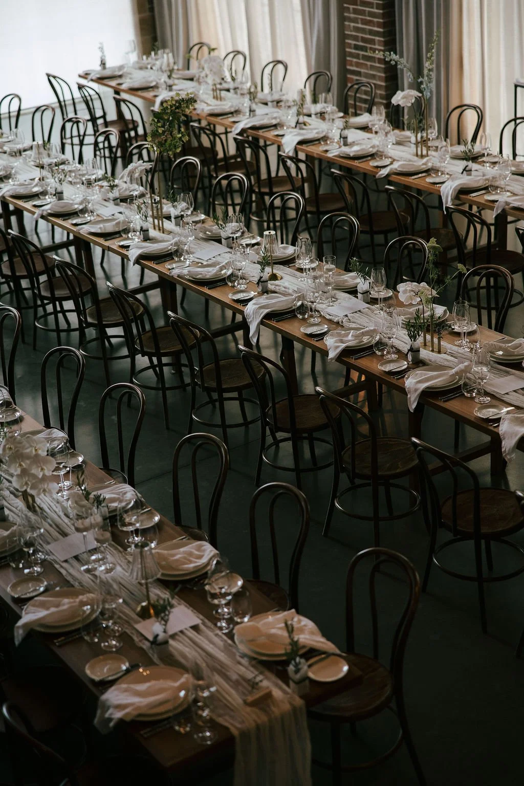 Candle and floral styling on tables of wedding 