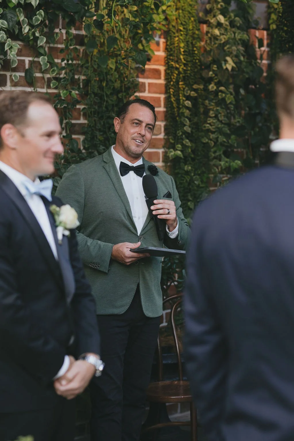 Celebrant leading the ceremony inside the Glass House