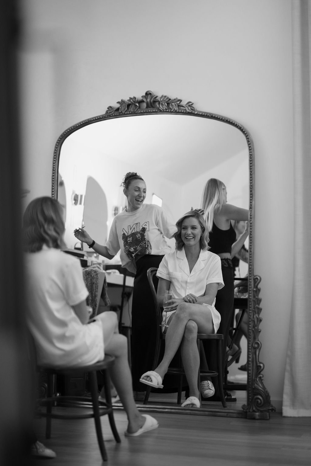 Bride getting hair done on wedding day 