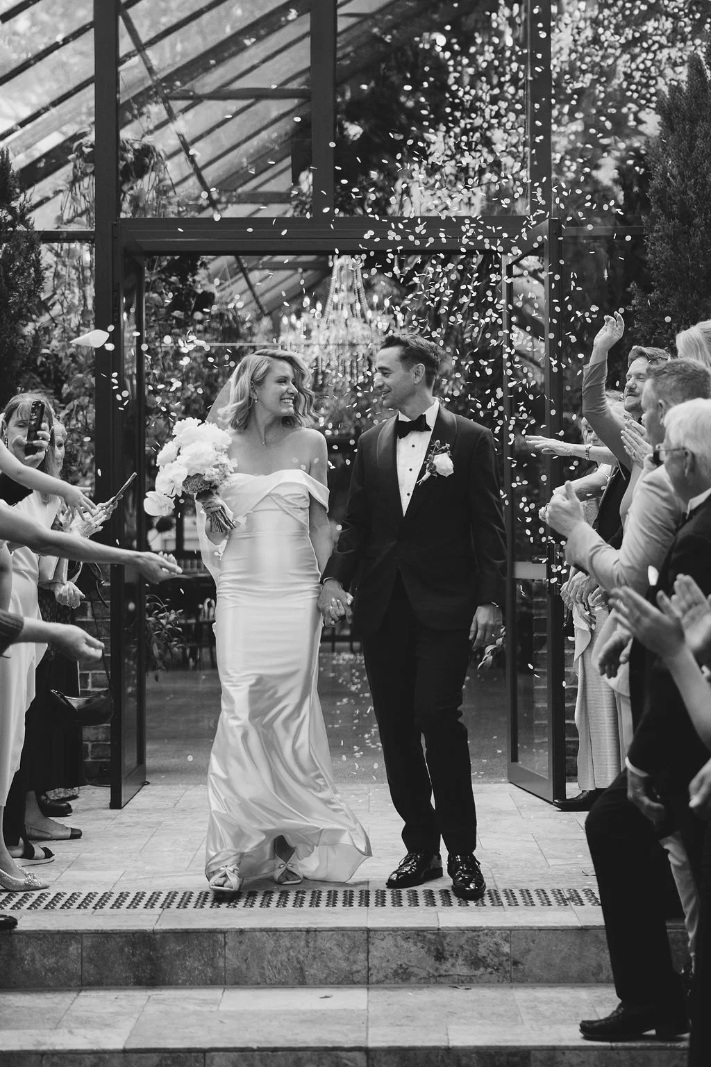 Confetti thrown as the couple exits the Glass House