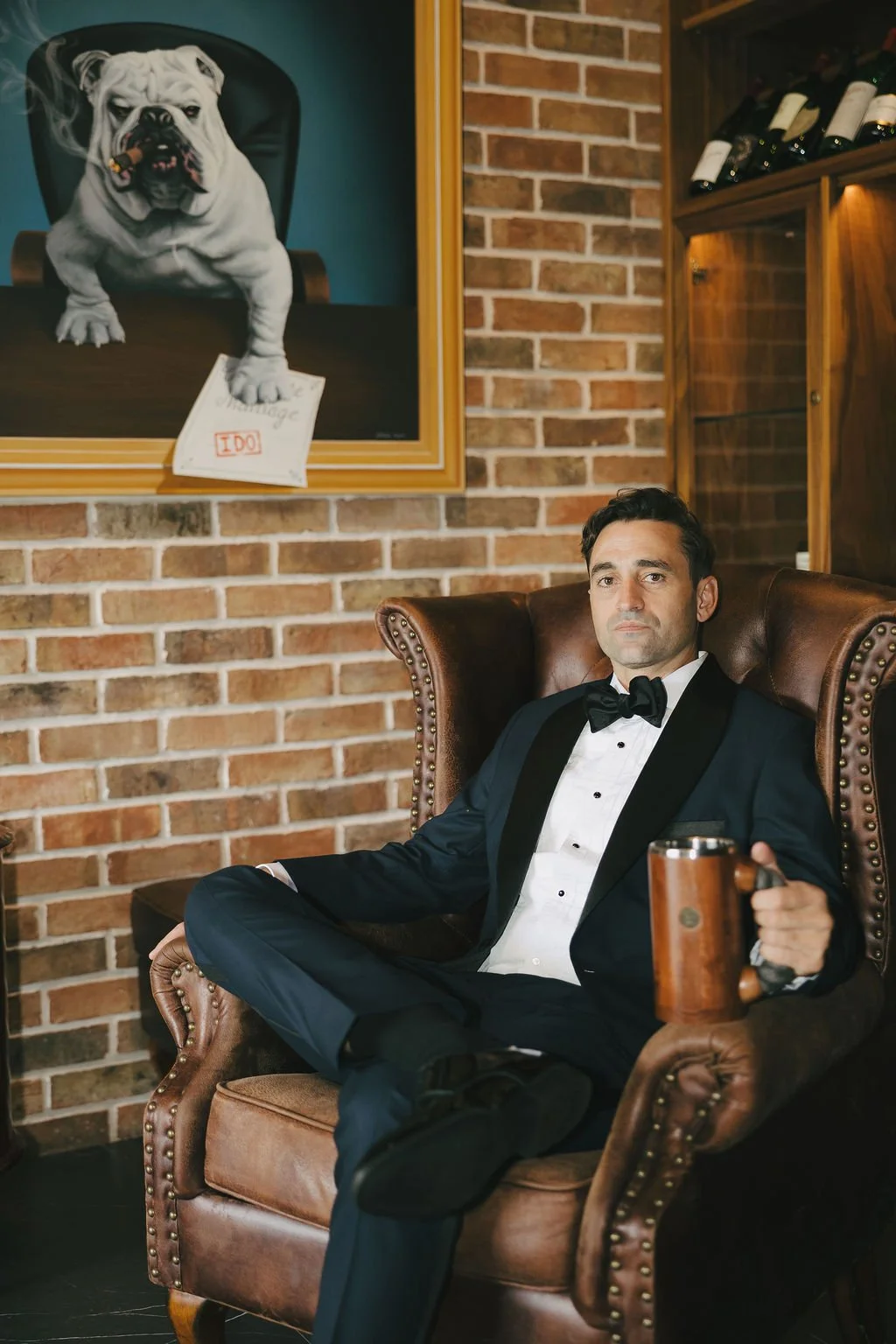 Groom having a drink at wedding 