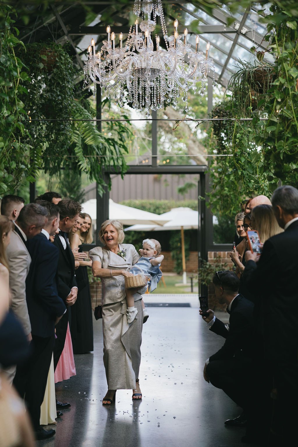 Flower girls walking down the aisle at the Glass House ceremony