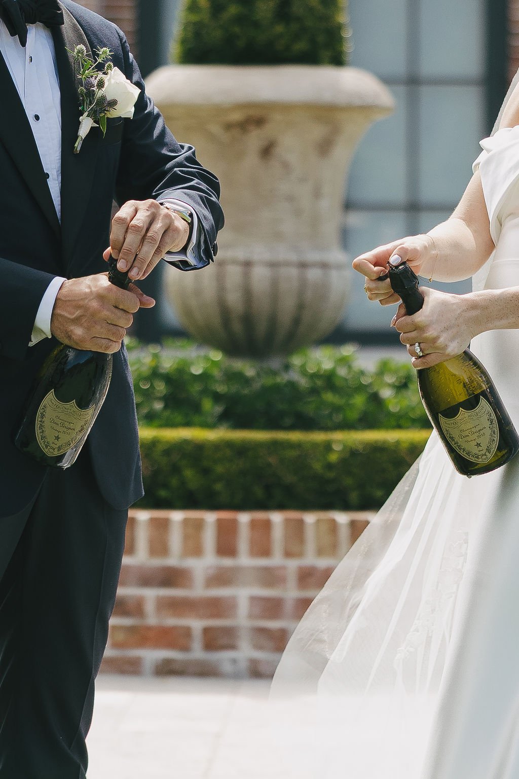 Champagne pop with bridal party on wedding day 