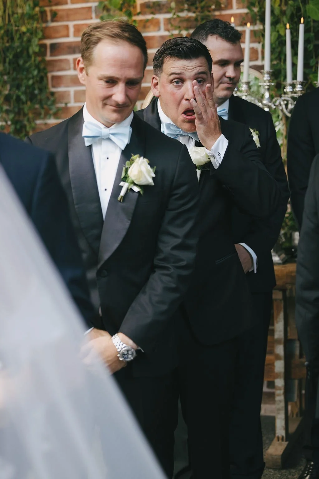 Guests wiping away tears during the vows