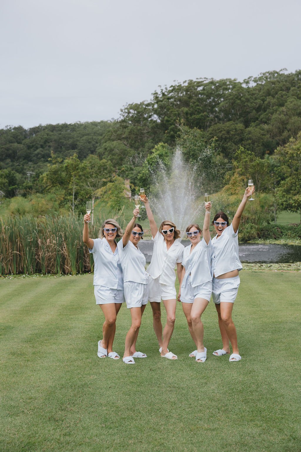 Bride and bridesmaids in robes before wedding 