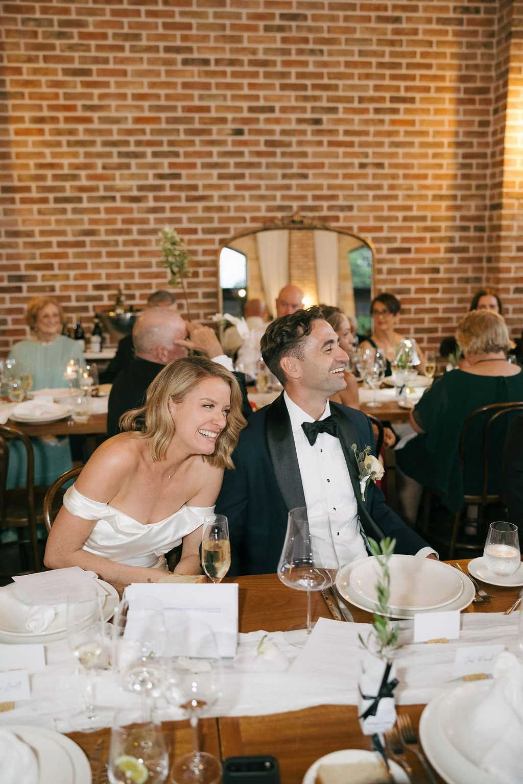 Groom laughing during a reception speech