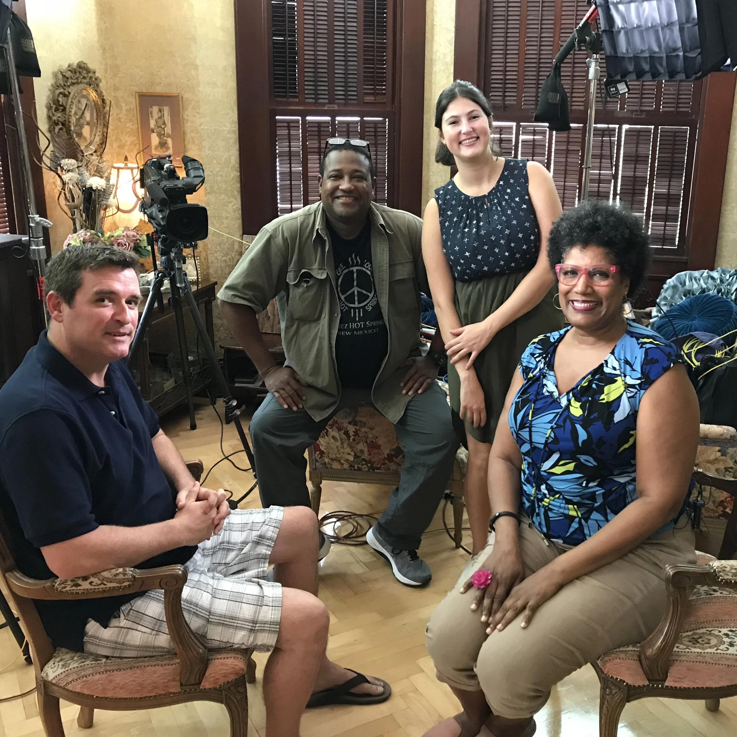 The cast and crew of CBS Sunday Morning and David Sloan are in a room at Key West's Curry Mansion Inn with a camera and studio equipment, smiling for a photo.