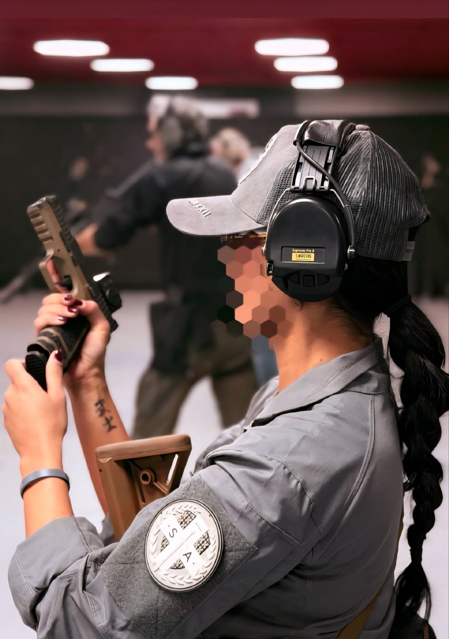 Close-up of an operator gripping a pistol and ballistic shield during tactical training at Swiss Training Academy. Precision, protection, and readiness in action