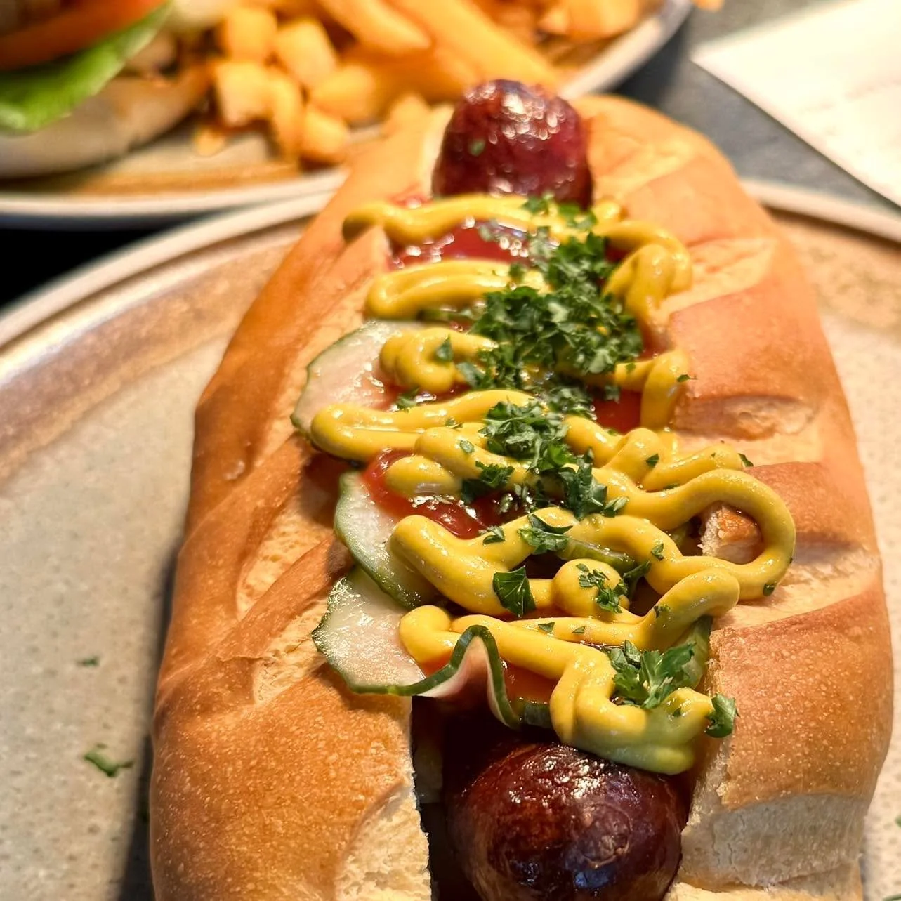 The popular Cranky Kransky. A grilled Kransky from our butcher with shredded Swiss cheese, house-made pickles, American mustard, grilled onions &amp; tomato sauce on our freshly house-made baguette.

#theartisanfarmernabiac #midnorthcoastnsw #barring