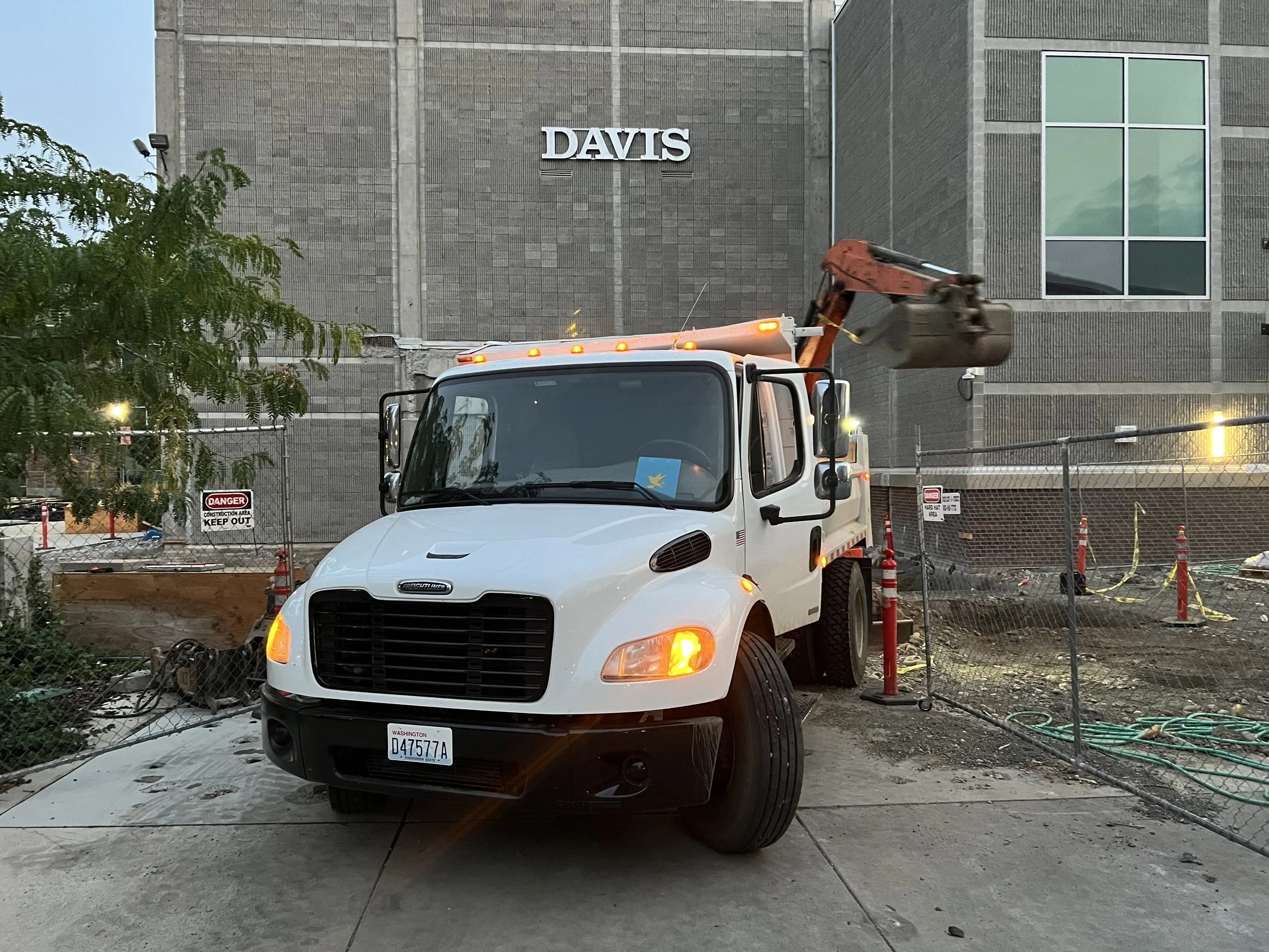 Construction site: a Hummingbird dump truck in front of an excavator at A.C. Davis High School.
