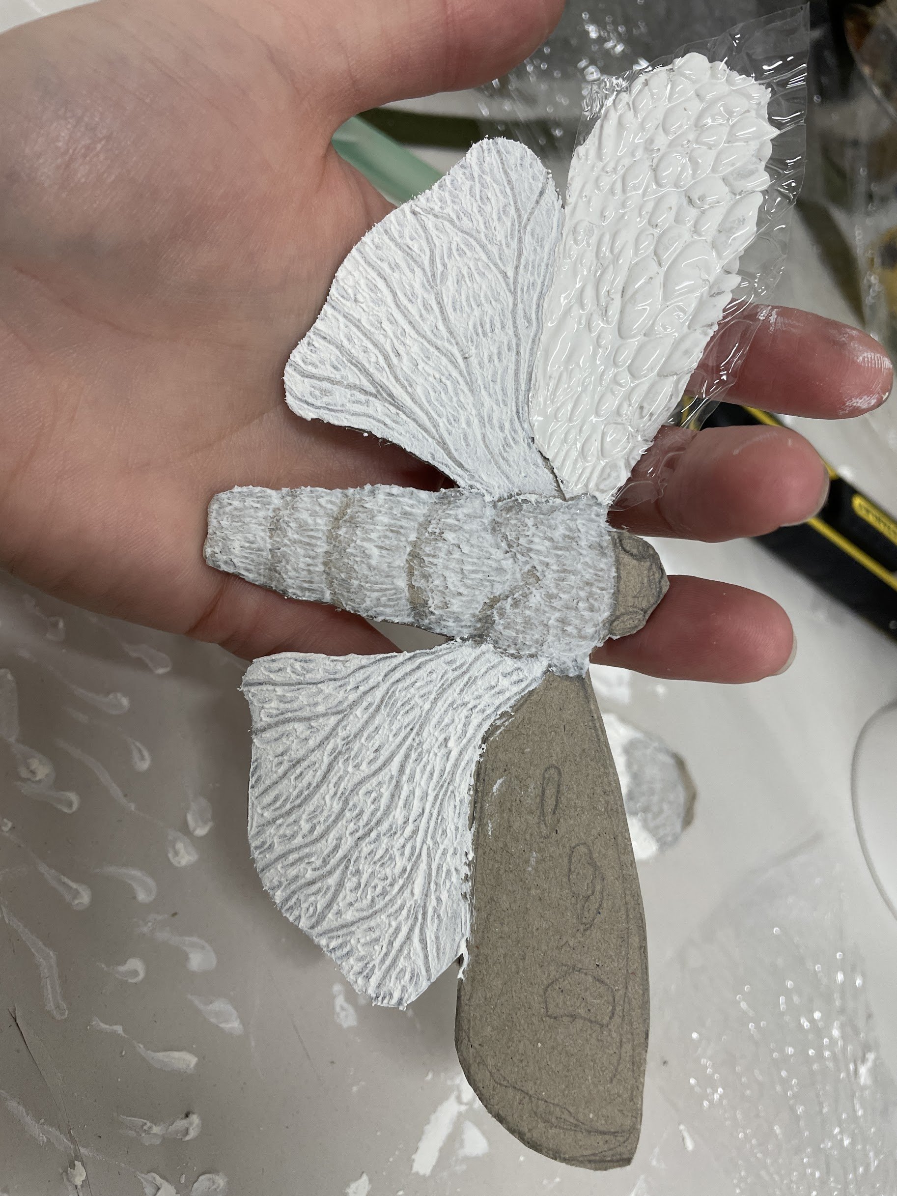 For the lower set of wings I applied more of the same product and scraped back and stippled with the brush end.