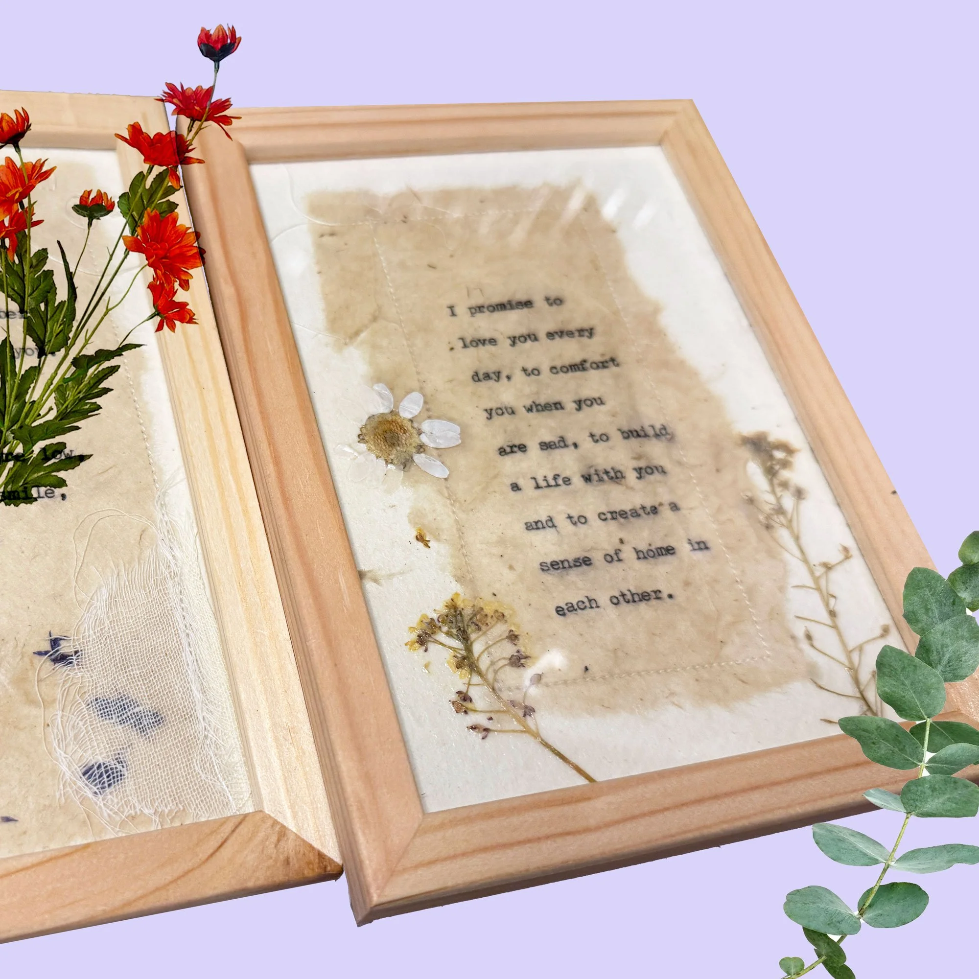 Wedding vow featuring a typewritten text framed uniquely on handmade paper with beautiful dried flowers flowers