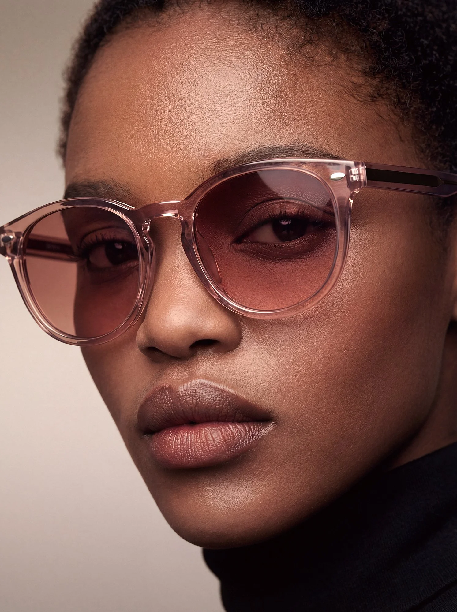 Close-up portrait of a woman wearing transparent pink sunglasses, AI-generated image refined with detailed Photoshop retouching and color correction.