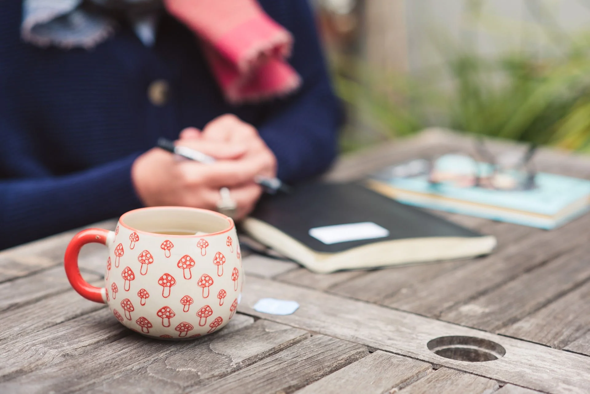 Jane Willis ready to hold a coaching session, with a pen, notebook and cup of tea