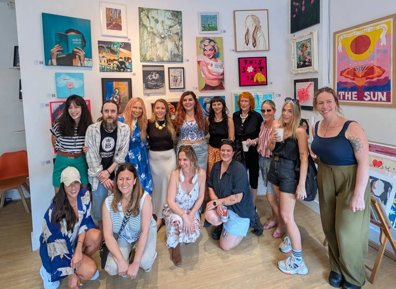 Group of emerging artists gathered inside The Gallery at the Playroom in Archway, London, during the Everyday Magic contemporary art exhibition organised and curated by Poppy Kettle.