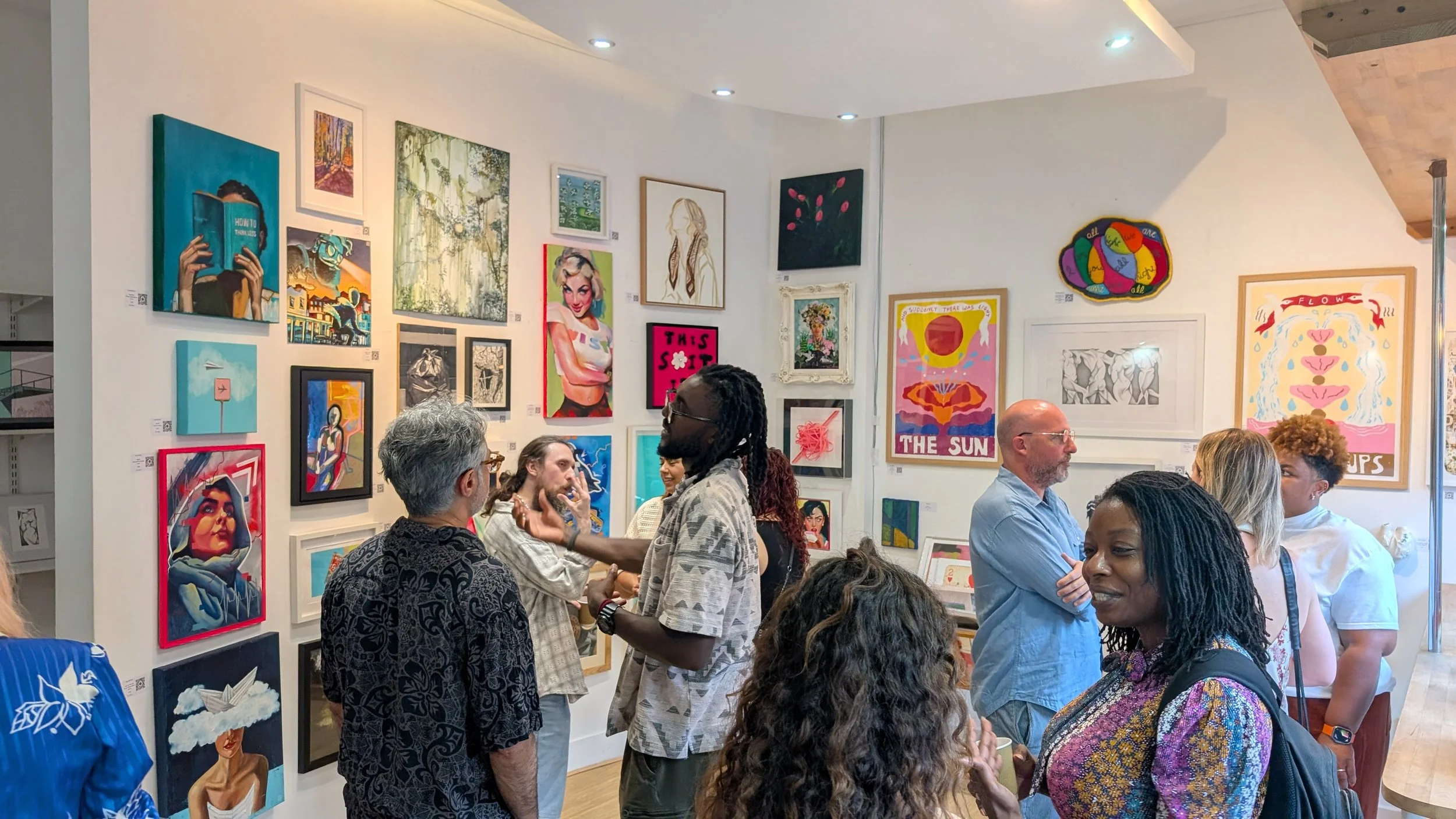 Busy opening night at the Everyday Magic contemporary art exhibition at The Gallery at the Playroom in Archway, London, with visitors viewing artwork by emerging London artists.