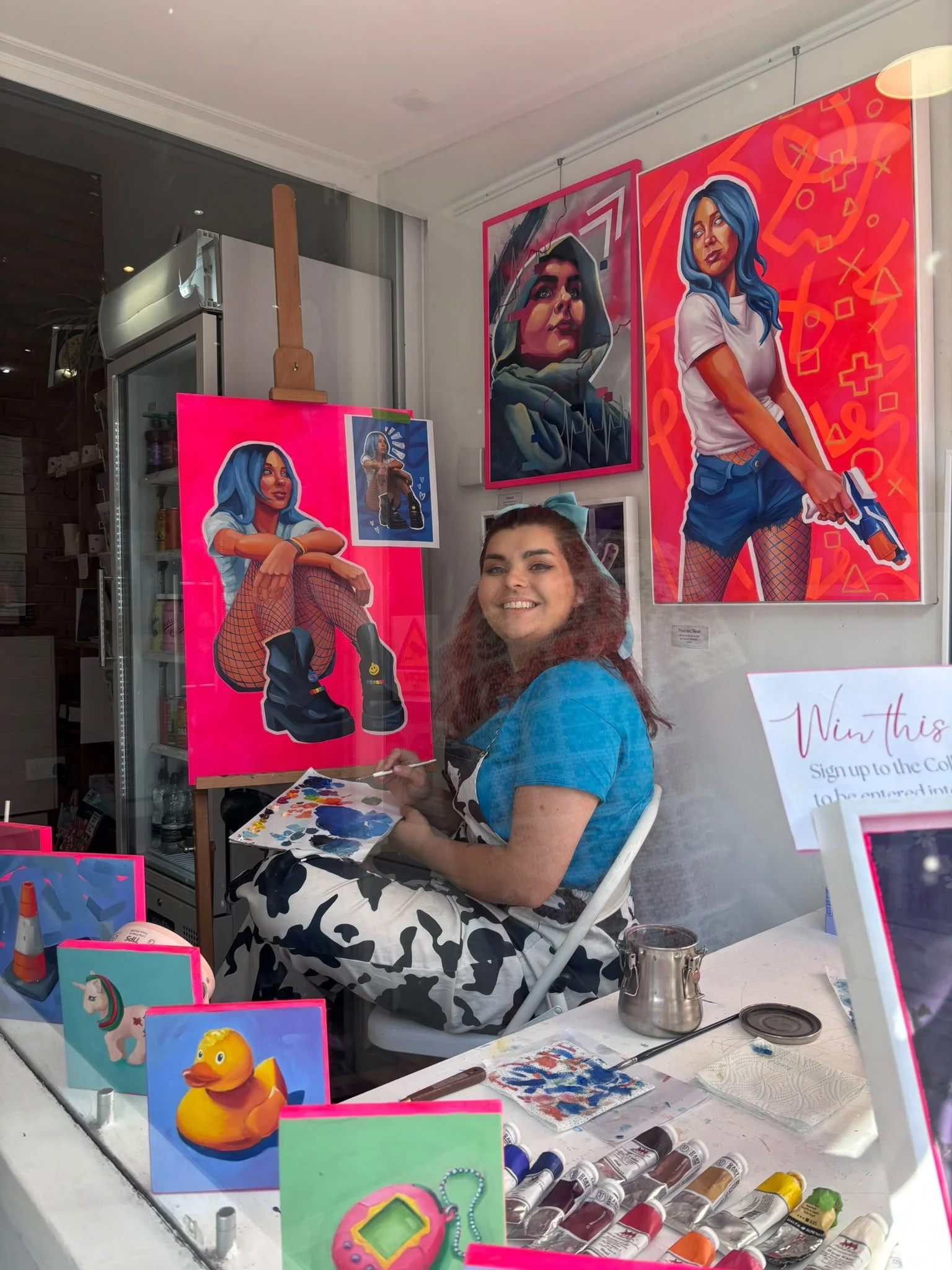 Guildford Artist Sam B. Kennedy painting in the window of Art Cafe 'Art and Grind'